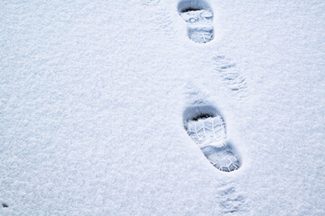 Footsteps on the ice covered with snow.