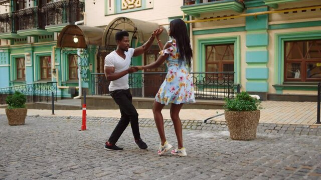 African american dancers performing in city. Couple dancing on street