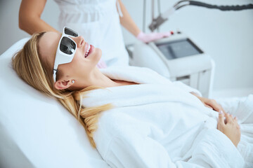 Cheerful woman client anticipating a beauty procedure
