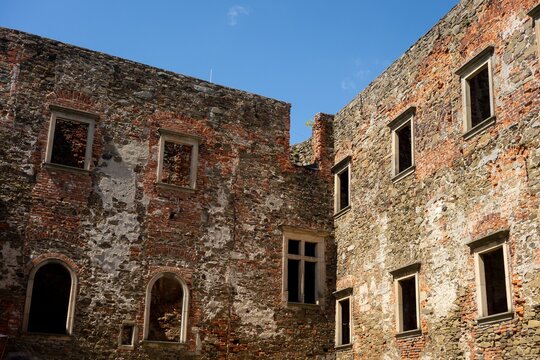 Ruined red brick walls and windows of Helfstyn castle in Czech Republic with blue sky