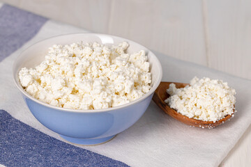 Bowl of cottage cheese on wooden table