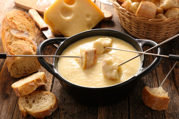 cheese fondue with wine and baguette