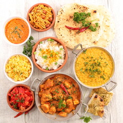 assorted of indian dish with curry dish, naan,  chicken