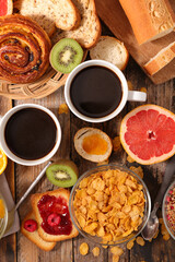 full breakfast- coffee cup,  baguette with jam and fruits