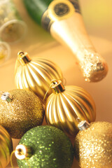 green and gold Christmas baubles on a beige background