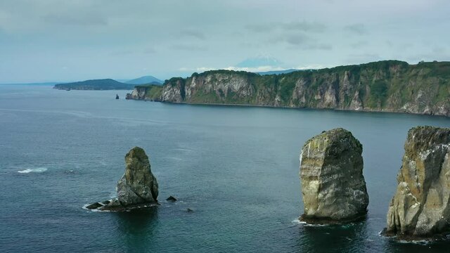 Aerial panorama view of Three brother rocks, Avacha bay, Kamchatka peninsula, Russia, 4k