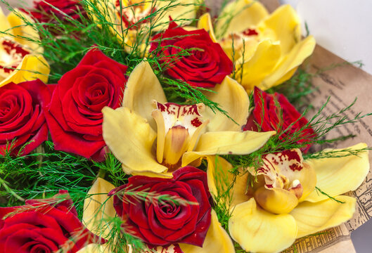 Bouquet of red roses and yellow orchids