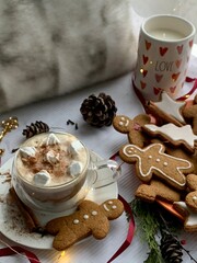 Christmas drink. Cup of hot chocolate with marshmallows and gingerbread cookies on festive background. Cozy Christmas time.