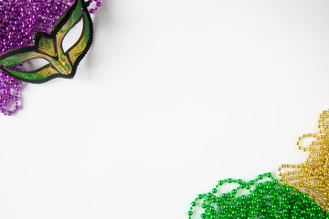 Mardi gras background on white with mask and beads and copy space