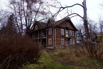 A very old, dilapitated, abandoned house, on a dark overcast day.
