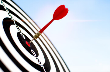 Close-up, target board and red darts in the middle of the target, target setting concept, goal...