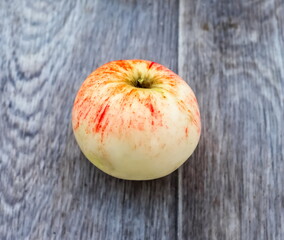 Apple closeup on a background of gray linoleum