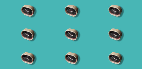 Mosaic of analog retro alarm clocks on cyan background. Multiplication.