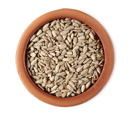 Peeled sunflower seeds in clay bowl isolated on white background, top view