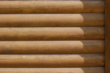 wall of the house is made of round logs