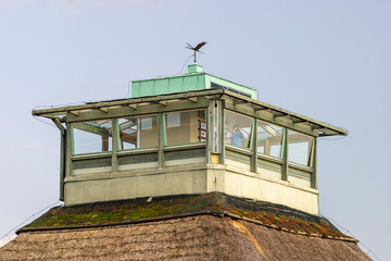 Bird watcher with binoculars in a bird tower