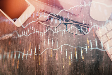 Multi exposure of forex graph hologram over desktop with phone. Top view. Mobile trade platform...