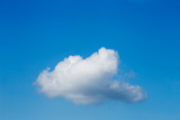 white cloud with a blue sky in the background.