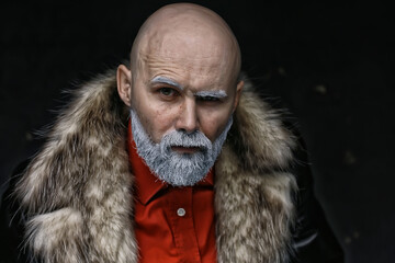 Santa Claus hipster / portrait of a fashionable modern Santa, young man with a gray beard, Christmas winter portrait