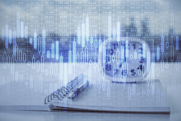 Multi exposure of financial graph drawings and desk with open notebook background. Concept of forex