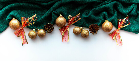 Banner with a green background in the form of a Christmas tree and Christmas toys in gold color in a minimalist style. Example of the site header design.