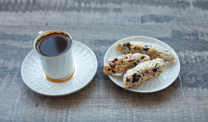 Christmas homemade cookies biscotti with dry berries and cup of coffee. Copy space.