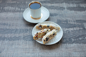 Christmas homemade cookies biscotti with dry berries and cup of coffee. Copy space.