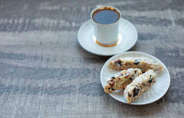 Christmas homemade cookies biscotti with dry berries and cup of coffee. Copy space.