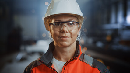 Portrait of a Professional Heavy Industry Engineer Worker Wearing Uniform, Glasses and Hard Hat in...