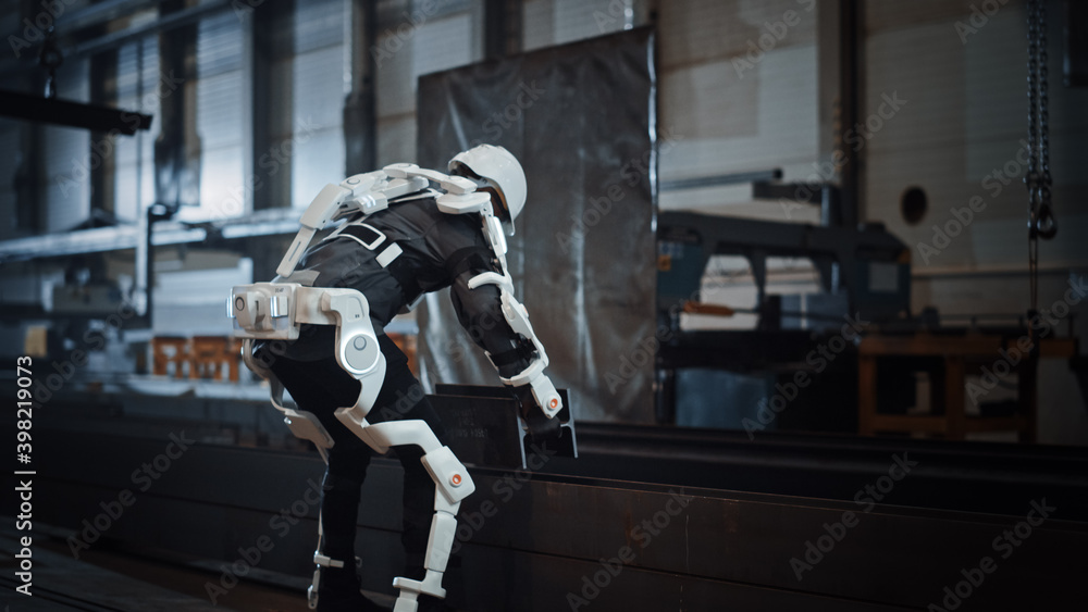 Aufkleber black african american engineer is testing a futuristic bionic exoskeleton and picking up metal obje