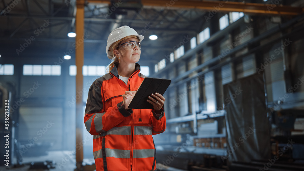 Wall mural professional heavy industry engineer worker wearing safety uniform and hard hat, using tablet comput