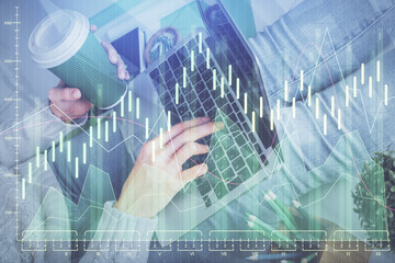Double exposure of woman hands typing on computer and forex chart hologram drawing. Stock market invest concept.