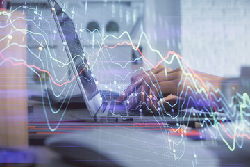 Double exposure of woman hands typing on computer and forex chart hologram drawing. Stock market invest concept.