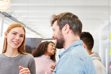 Fototapeta premium Young students or colleagues in small talk