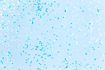 Blue background with sequins. Suitable for backdrop for your design. Top view, copy space