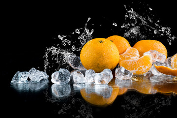 Fototapeta na wymiar tangerines on a black background, water splash, crushed ice, ice cubes