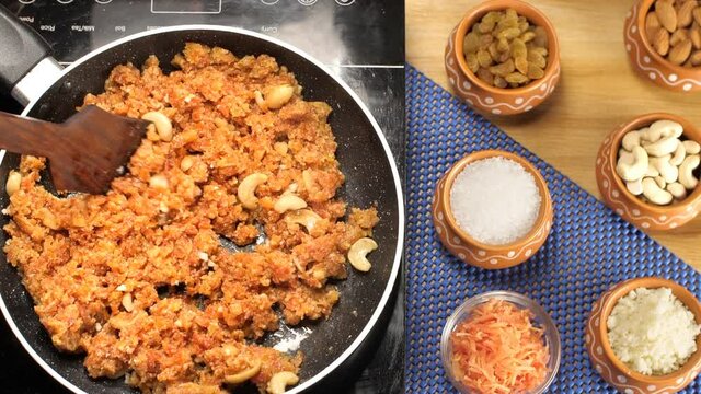 Stirring of Gajar Halwa/carrot pudding made with lots of Desi Ghee and dry fruits. Closeup shot of raw ingredients of Gajar Ka Halwa placed on a wooden table with a blue mat - traditional Indian sw...
