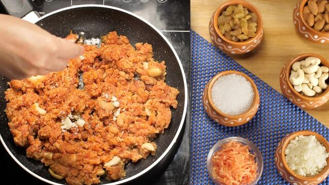 Cooking of grated carrot for preparation of Indian sweet/dessert - carrot/Gajar Halwa. Closeup shot of female's hand sprinkling dry Khoya/Mawa in traditional Gajar Halwa cooking in a frying pan