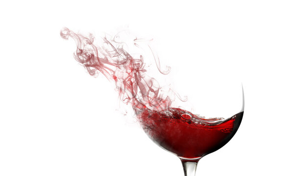 Smoke swirls fading from a red wine glass isolated on white background with space for text and images.Wine tasting concept.