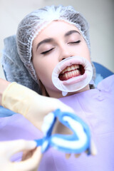 Professional teeth cleaning. Caries prevention. A young girl at the dentist's appointment....
