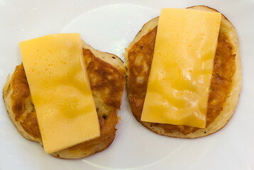 Pancakes with cheese on white background