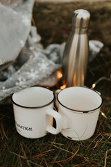 autumn fall camping mugs with tea. couple drinking hot tea on a forest trail. autumn mugs. close up