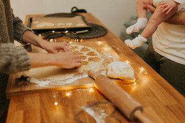 Christmas baking. Cooking Christmas gingerbread. Damily decorating freshly baked cookies with icing, close up. Festive food, family culinary, Christmas and New Year traditions concept