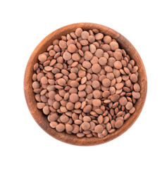 Brown lentils in wooden bowl, isolated on white background. Top view.