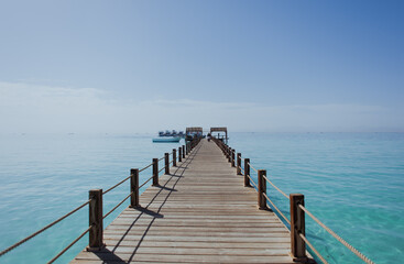man walks across the bridge. Around blue Water. Sea. Ocean. Summer, Heat. Egypt. Orange bay