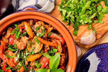 Ajapsandal.  Traditional Georgian appetizer cooked from aubergine, pepper, onion, carrot, tomato, garlic, basil, parsley and different sorts of herbs and spices in а clay blue casserole dish.