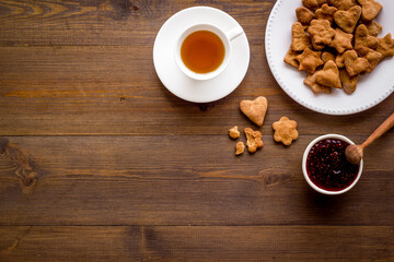 Chocolate cookies flat lay with berry jam and tea