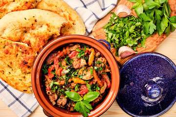 Ajapsandal. Traditional Georgian appetizer cooked from aubergine,pepper, onion, carrot, tomato, garlic, basil, parsley and different sorts of herbs and spices in а clay blue casserole dish with bread.