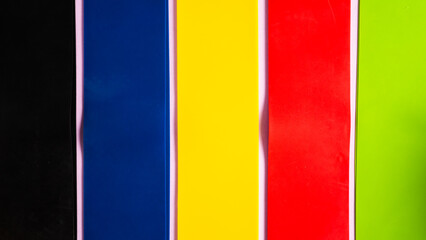 Fototapeta premium The colorful vertical lines of resistance bands. The colorful fitness band set. Resistance bands bodybuilding