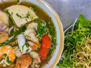Bowl of colorful and delicious Vietnamese seafood noodles soup